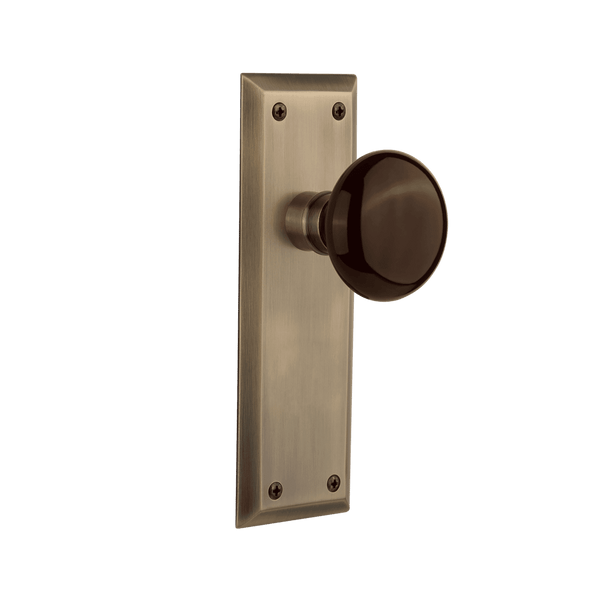 New York Long Plate with Brown Porcelain Knob in Antique Brass